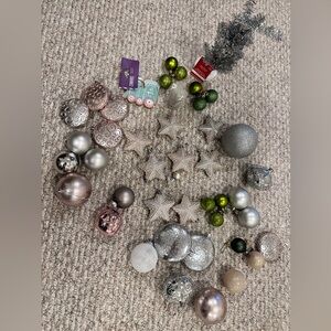 Various light blush, pink Christmas tree ornaments, and silver round